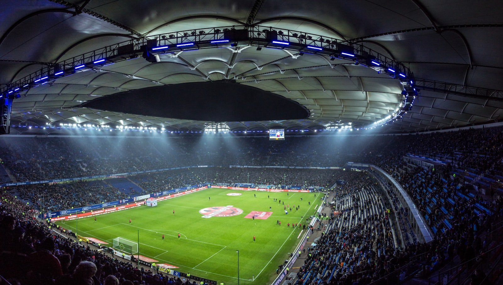 Football stadium under floodlights